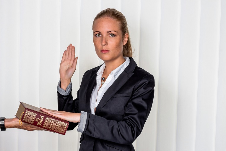 "business woman with hand on Bible"