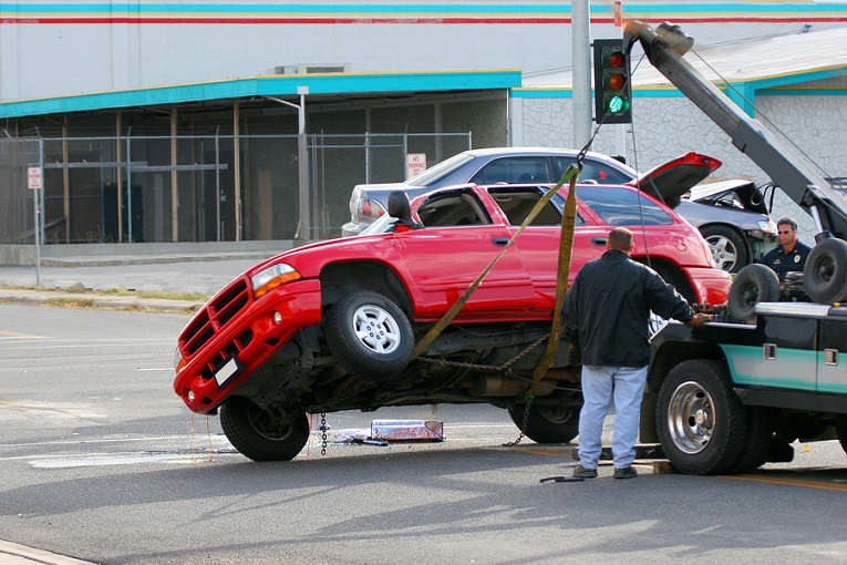 "red truck being towed"