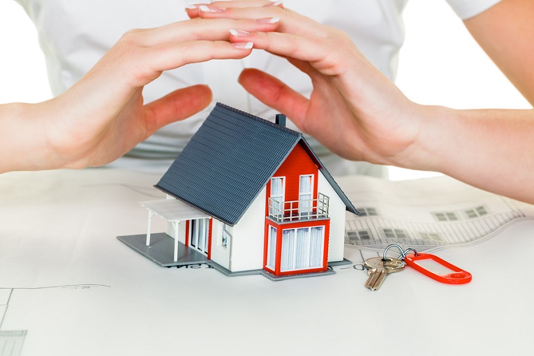 "hands protecting small house"