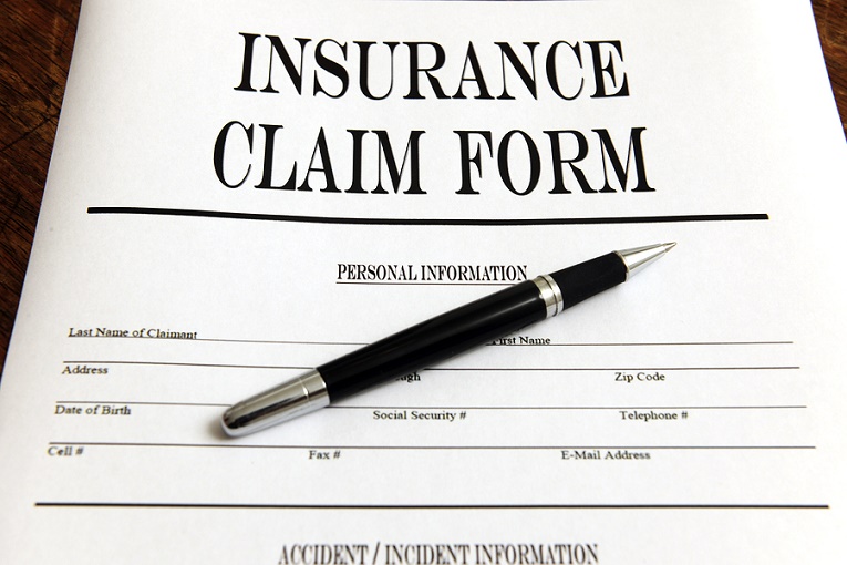Pen on top of insurance claim form
