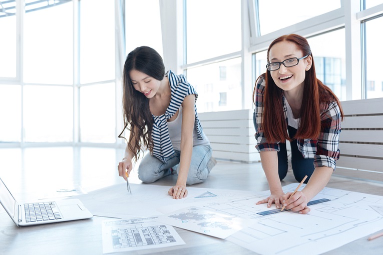 "Two women drawing on floors"