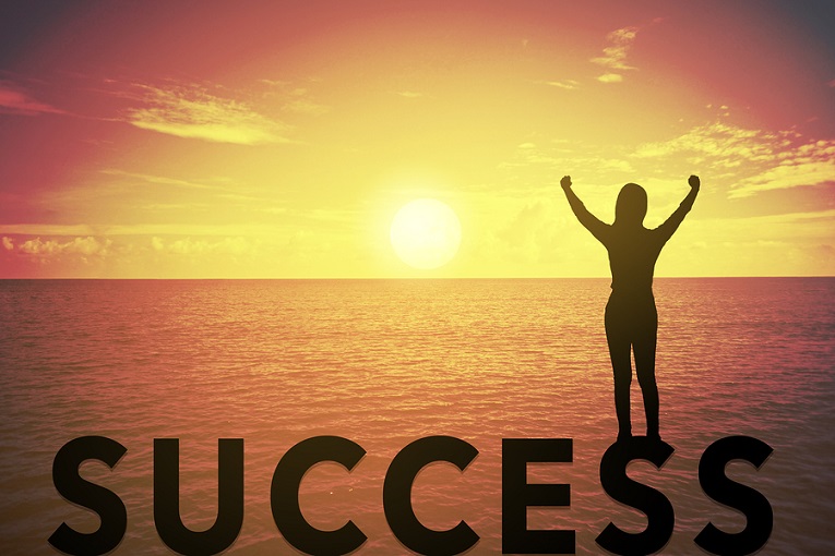 "woman with hands in air looking at sunset, success"