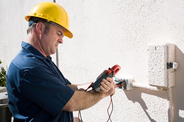Electrician measuring voltage on home