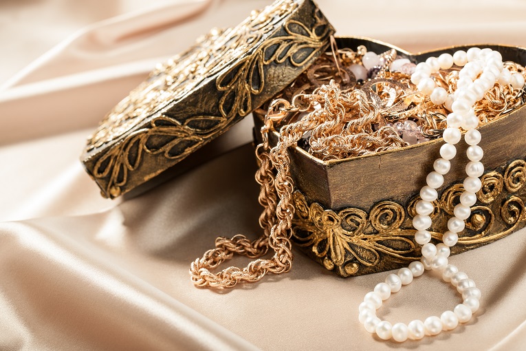 Jewelry box opened with gold and pearl necklaces inside