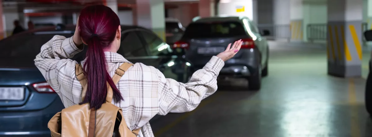 woman in parking garage looking for her car