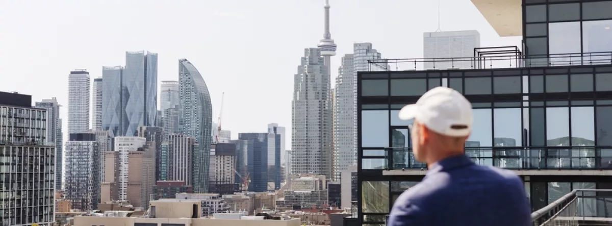 man standing on balcony of condo