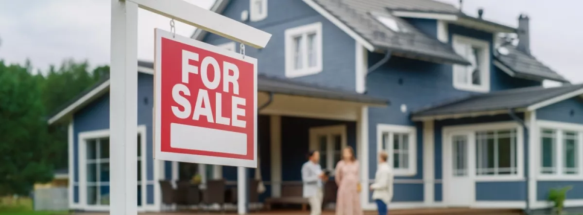 home with for sale sign on front lawn
