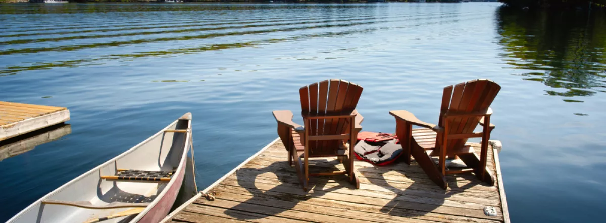lake dock with chairs and canoe
