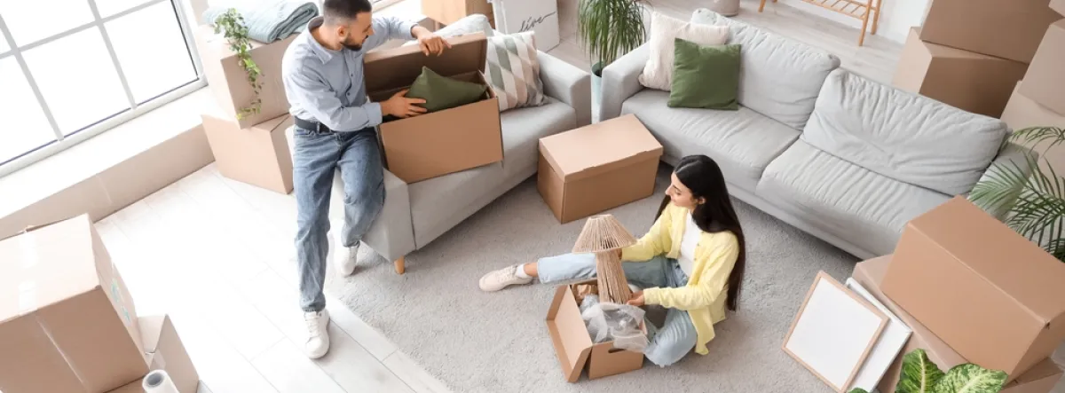 Couple packing boxes to move