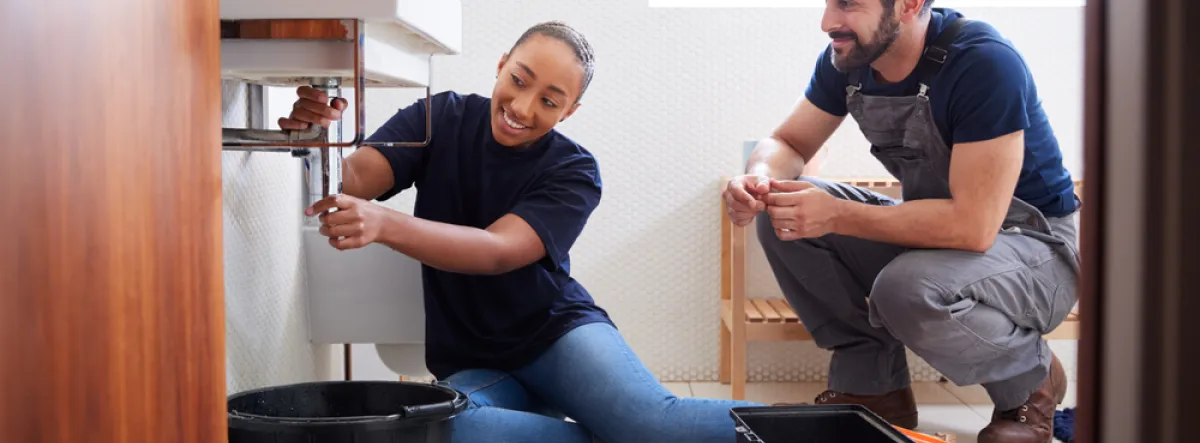 couple fixing bathroom leak