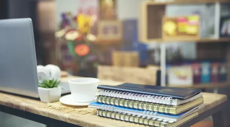 laptop and books on desk for studying