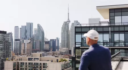 man standing on balcony of condo