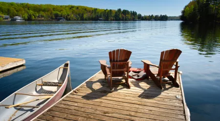 lake dock with chairs and canoe