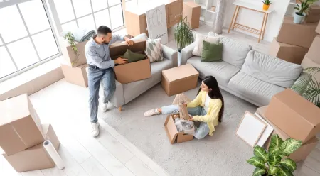 Couple packing boxes to move