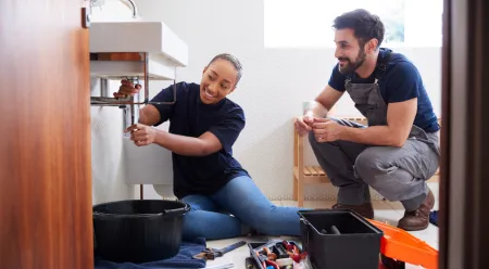 couple fixing bathroom leak