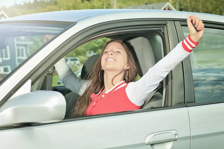 Young girl driving car